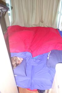 The settee turned bed in the camper we rented for three - cold - weeks in New Zealand
